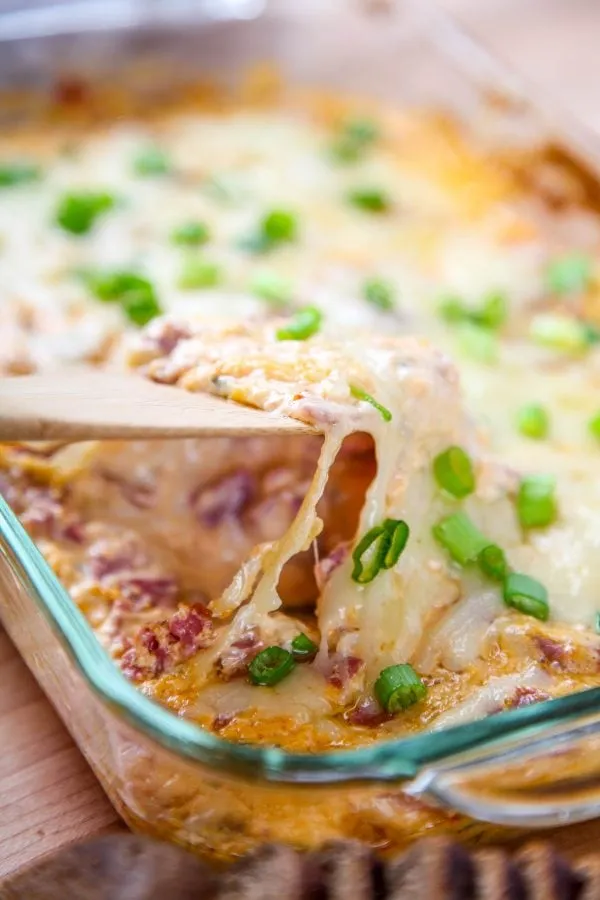 This baked Reuben dip has all the bold flavors of the classic sandwich in warm, creamy form. Salty corned beef, tangy sauerkraut, melty cheese, and that signature dressing bake together into a hot dip that tastes just like a Reuben — and disappears just as fast at parties and game day gatherings.