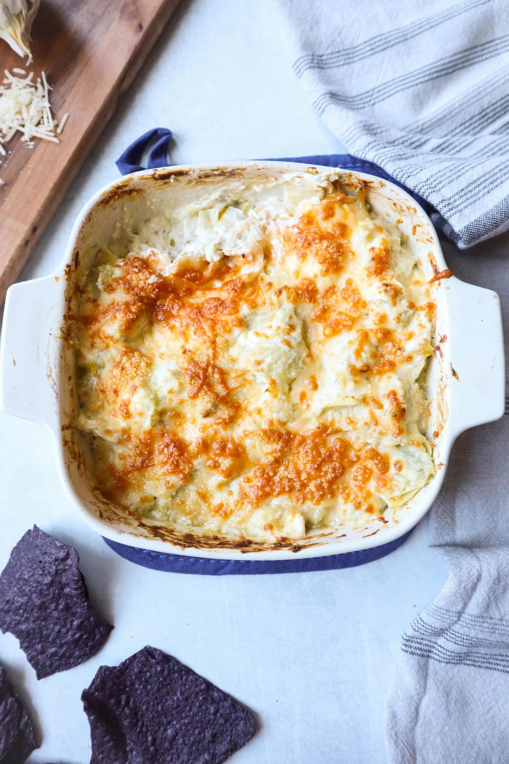 This green chile artichoke dip is rich, creamy, and packed with cheesy goodness. The combination of savory artichokes and mildly spicy green chiles gives it just the right kick, then it’s baked and broiled until hot, bubbly, and perfectly caramelized on top. A warm, savory dip that’s very hard to stop scooping.