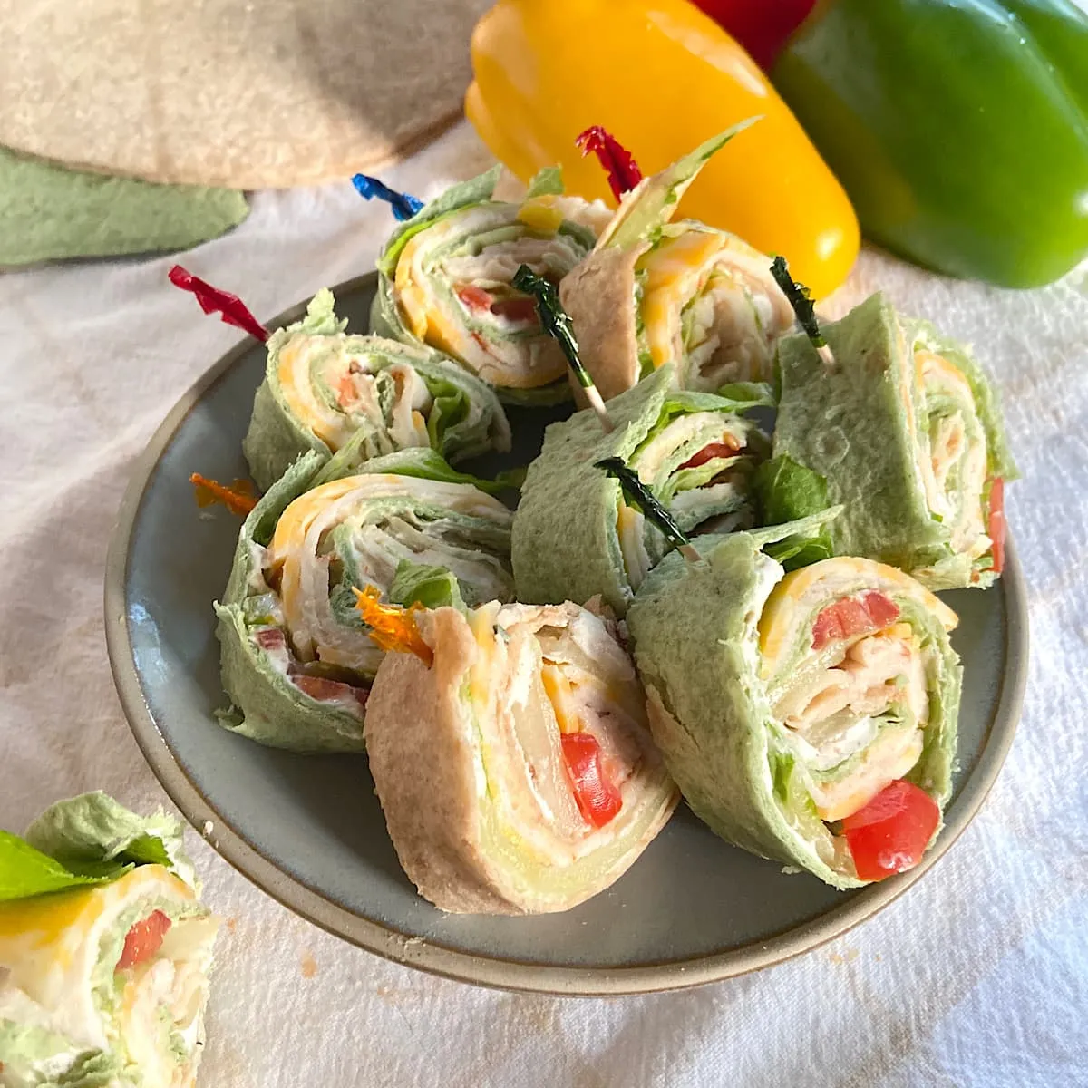 These buffalo chicken pinwheels are colorful, flavorful, and easy to grab. Spicy chicken is rolled up with cheese, crisp lettuce, bell peppers, and a creamy spread for a filling, handheld bite. Perfect for parties or game day, they’re a lighter pinwheel option that still delivers big flavor.