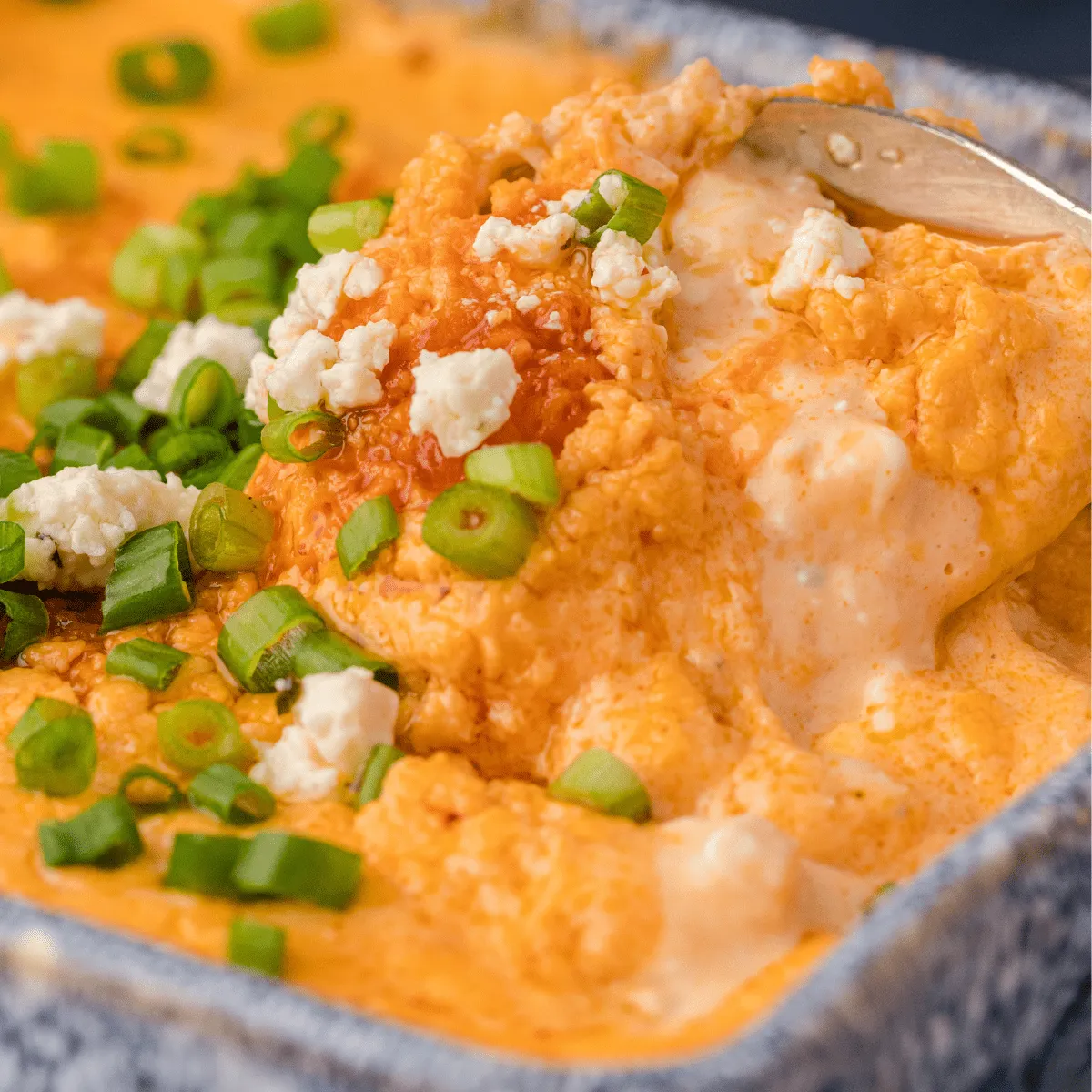This buffalo chicken dip is one of the easiest appetizers you can bring to a potluck or party. Made with just five ingredients, it comes together fast and can be cooked in the microwave, oven, Instant Pot, or slow cooker — whatever works best for you. All the bold, cheesy buffalo wing flavor you love, but in a scoopable dip that’s easy to serve and even easier to finish.