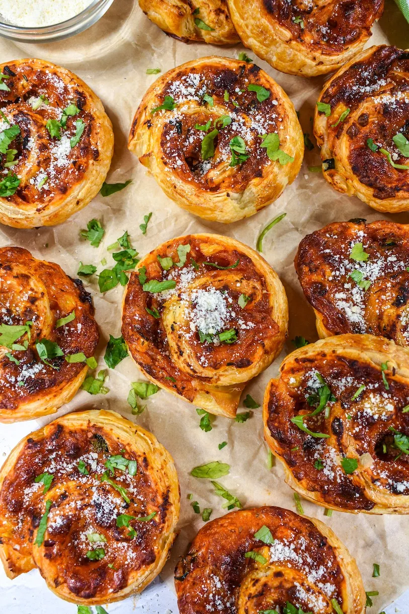 These jalapeño pineapple pizza rolls are sweet, spicy, and ridiculously easy to make. Puff pastry gets rolled up with zesty tomato sauce, jalapeños, juicy pineapple, and two kinds of melty cheese, then baked until golden and flaky. Perfect for parties and game day, they’re fun finger food with just the right kick.