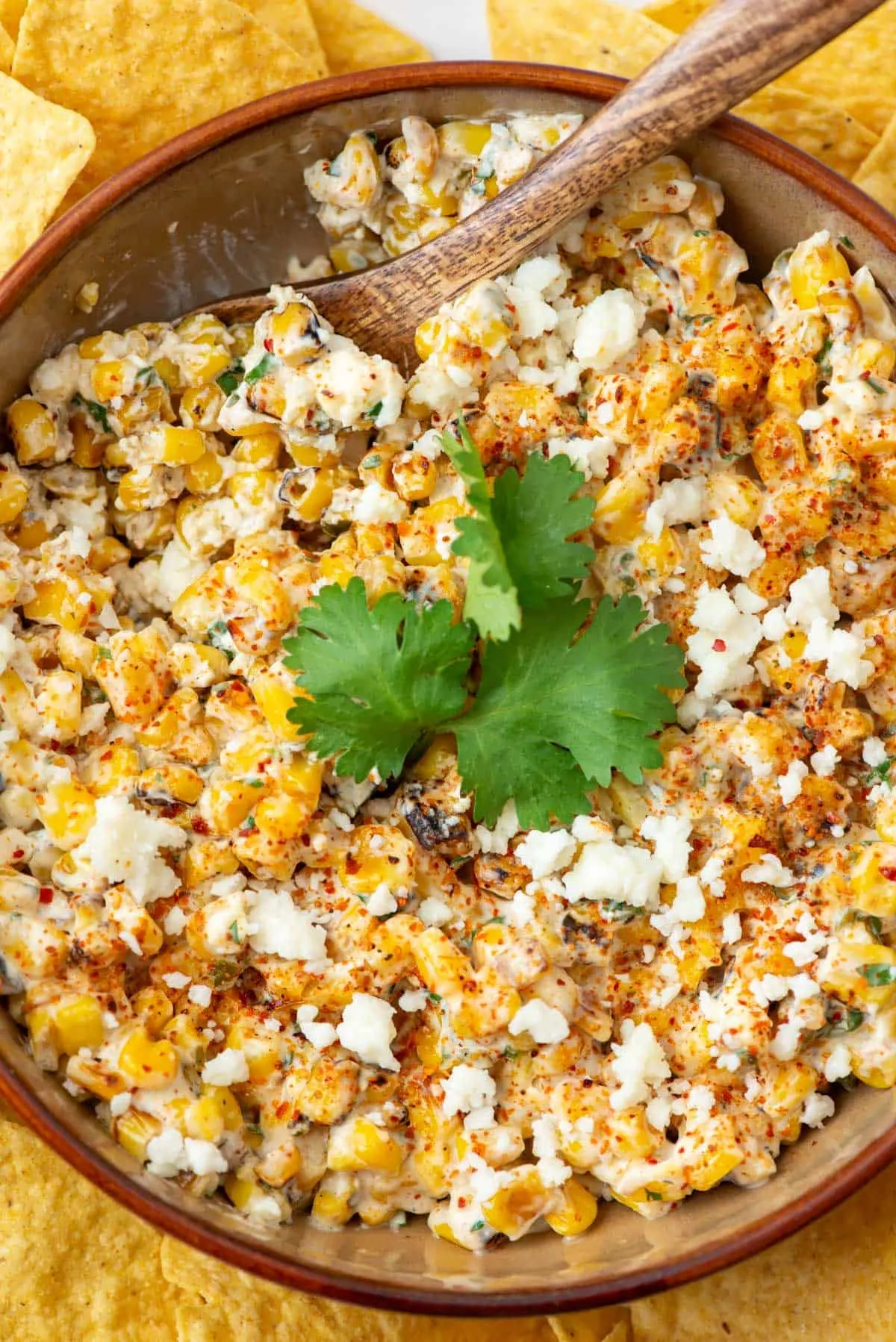 This Mexican street corn dip takes everything you love about elote and turns it into a warm, cheesy appetizer. Roasted corn, crema, lime, cotija cheese, and a sprinkle of Tajín come together for a bold, tangy dip that’s impossible to stop scooping. Serve it hot with tortilla chips and watch it disappear fast at any party.
