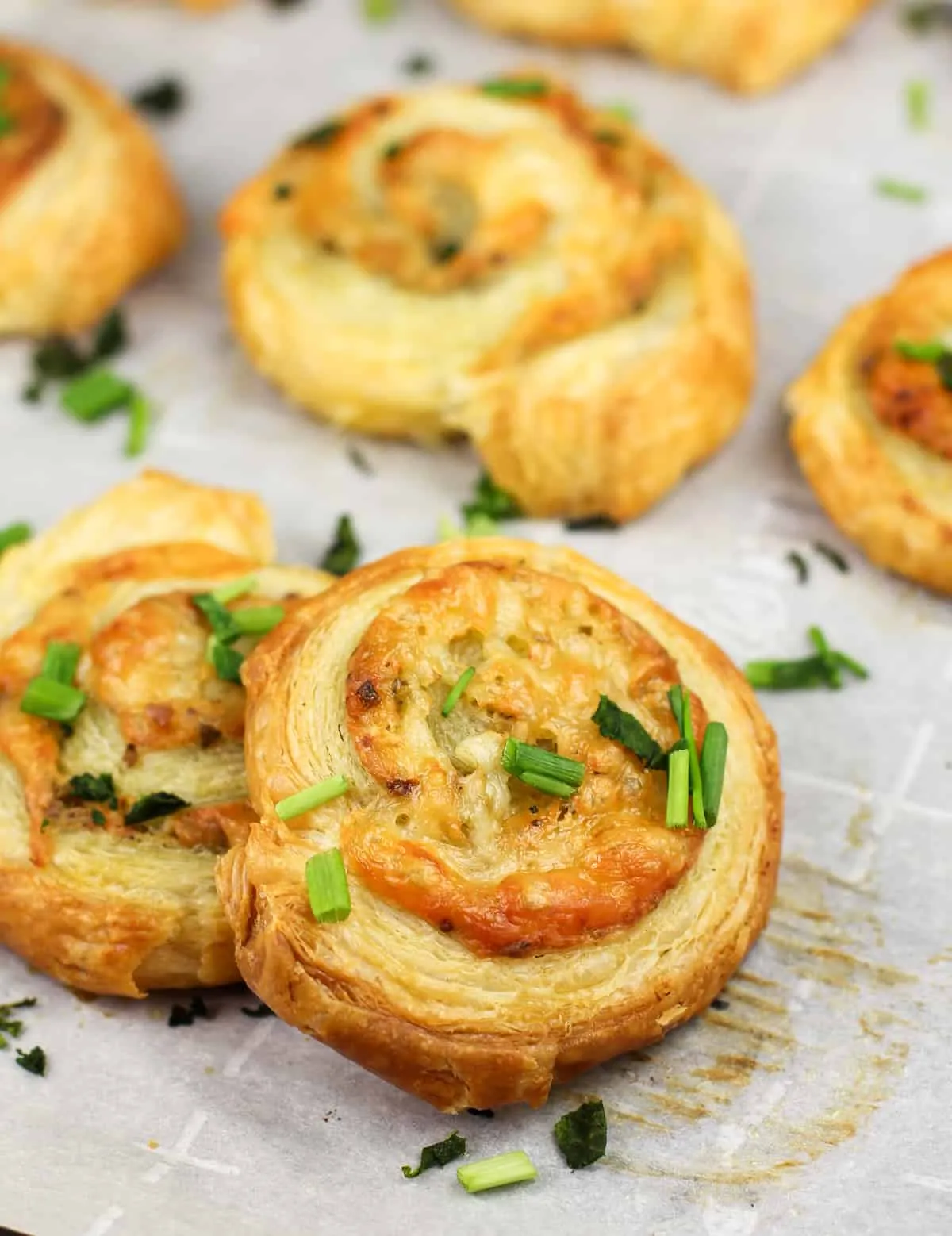 These pesto puff pastry pinwheels are flaky, cheesy, and packed with bold flavor. Pesto, tangy Dijon, whole grain mustard, and plenty of cheese get rolled up in puff pastry and baked until crisp and golden. Ready in minutes and super easy to make, they’re perfect as a quick snack, party nibble, or crowd-pleasing appetizer.