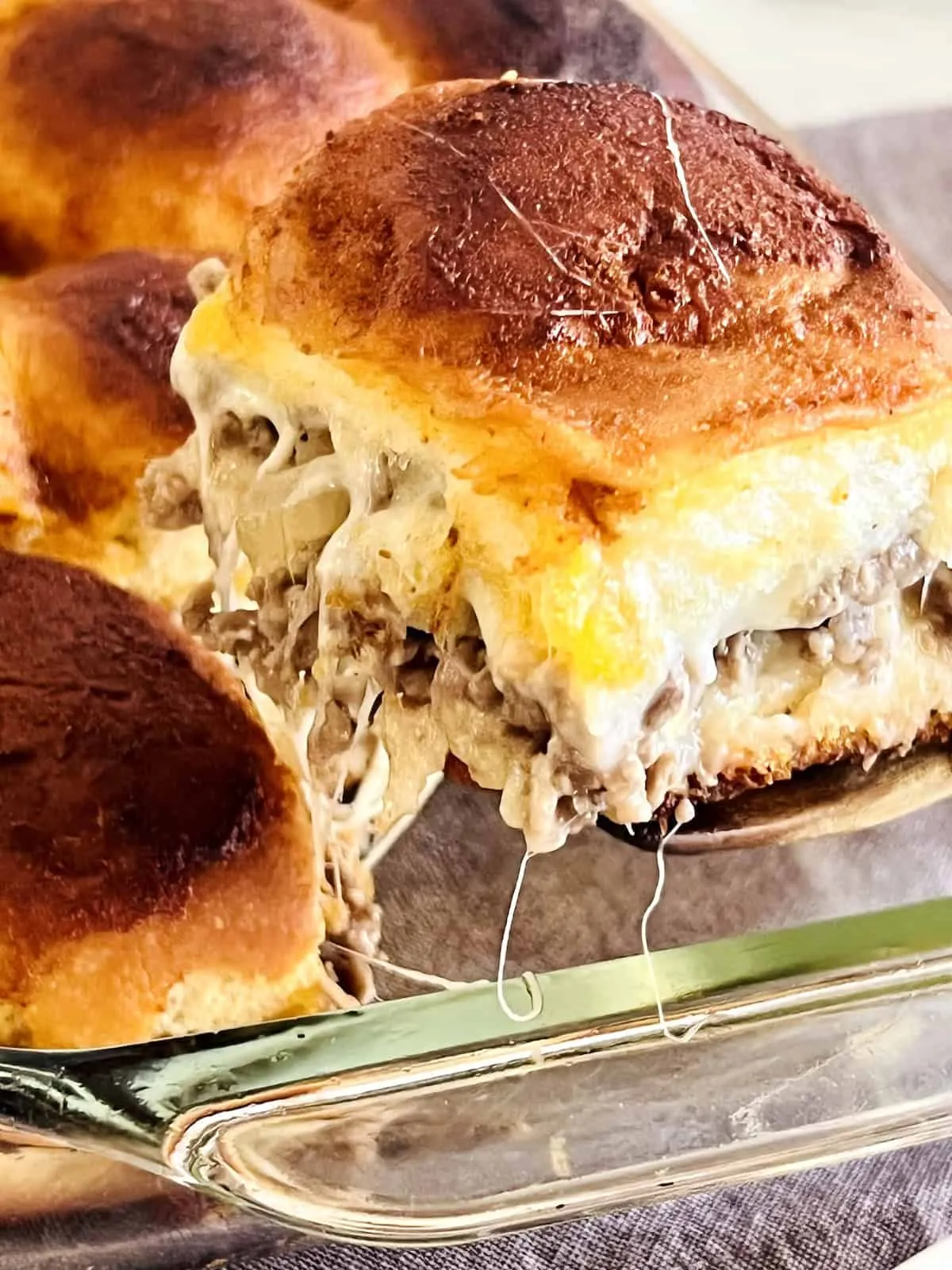 These Philly cheesesteak sliders on Hawaiian rolls are sweet, savory, and completely irresistible. Piled high with seasoned sliced beef, caramelized onions, and melty provolone, they’re easy to make and perfect for snacking, parties, or game day spreads. Bake up a batch and don’t expect leftovers.