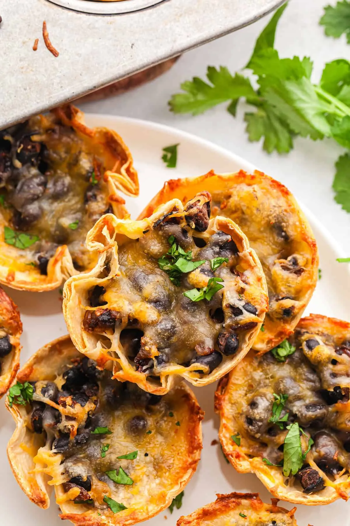 These taco bites are the kind of easy appetizer everyone loves. All the flavor of tacos is tucked into crispy little tortilla cups, so there’s no mess and no juggling plates on game day. Made with black beans for a hearty vegetarian option, they’re easy to customize with taco meat, ground turkey, or refried beans depending on what you have on hand.