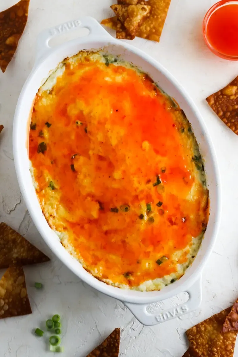 This crab rangoon dip takes everything you love about the classic appetizer and turns it into a hot, scoopable favorite. Creamy, cheesy crab dip bakes up in one dish and gets served with homemade wonton chips for dipping — all the flavor, none of the deep frying. Made with simple ingredients and perfect for parties, it’s a fun twist that always disappears fast.