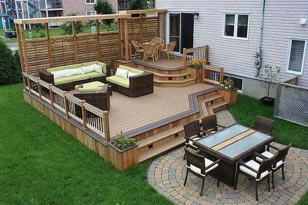This two-level backyard deck with defined seating areas is a great option if you want multiple zones without going full luxury build. The lower level creates a relaxed lounging space, while the upper section works perfectly for dining or morning coffee just outside the house. The simple privacy screen adds separation without closing the space in, making it ideal for backyard deck ideas for small yards or close-together homes where a bit of screening makes a big difference. This is also a strong example of backyard deck ideas two levels and backyard deck ideas with stairs that feel practical and achievable, especially if you’re upgrading an existing deck rather than starting from scratch.