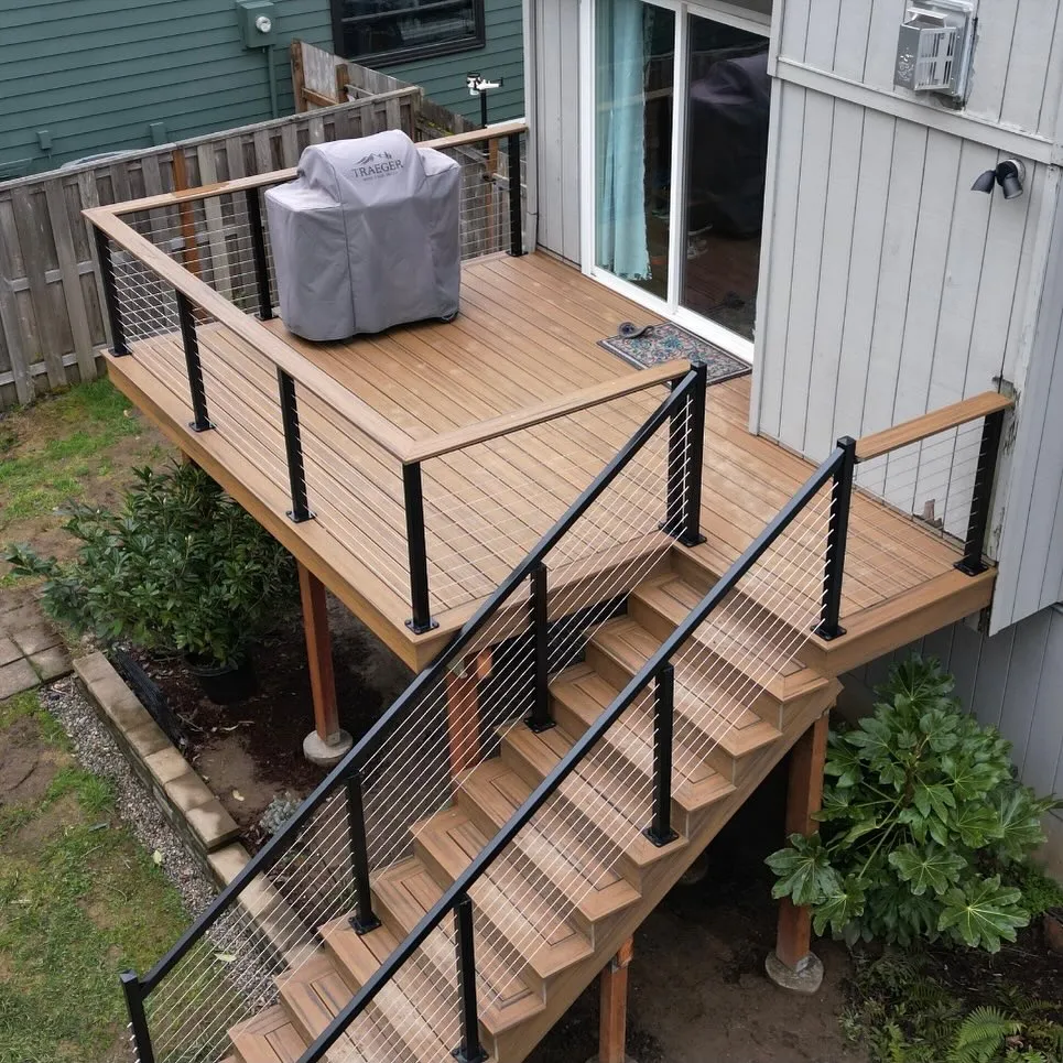 This raised backyard deck with stairs is a smart solution when your back door sits higher than the yard and you need something practical that still looks good. The clean lines, simple railing, and straight run of steps make it feel modern without being flashy, which is perfect if you want a deck that blends into the house rather than stealing the show. This setup works especially well for small yards or narrow spaces, where a sprawling deck just wouldn’t make sense. It’s also a great example of backyard deck ideas with stairs done right — easy access, no wasted space, and plenty of room for a grill or small seating area without overcomplicating the layout.