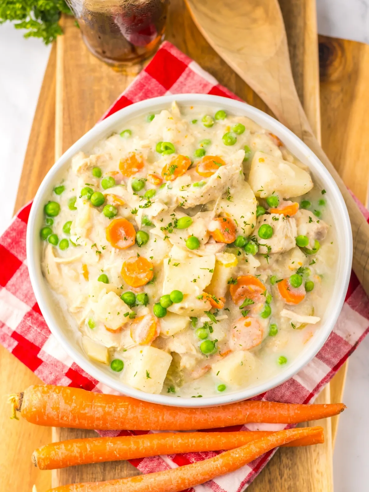 This is cold-weather comfort food at its finest. Chicken, potatoes, carrots, and onions simmer all day in a flavorful broth until everything is melt-in-your-mouth tender. Then you stir in a little cream right at the end — just enough to make it cozy without feeling heavy — and finish with sweet peas for a pop of color. It’s simple, homemade, and the kind of stew that makes everyone wander into the kitchen asking when dinner’s ready.