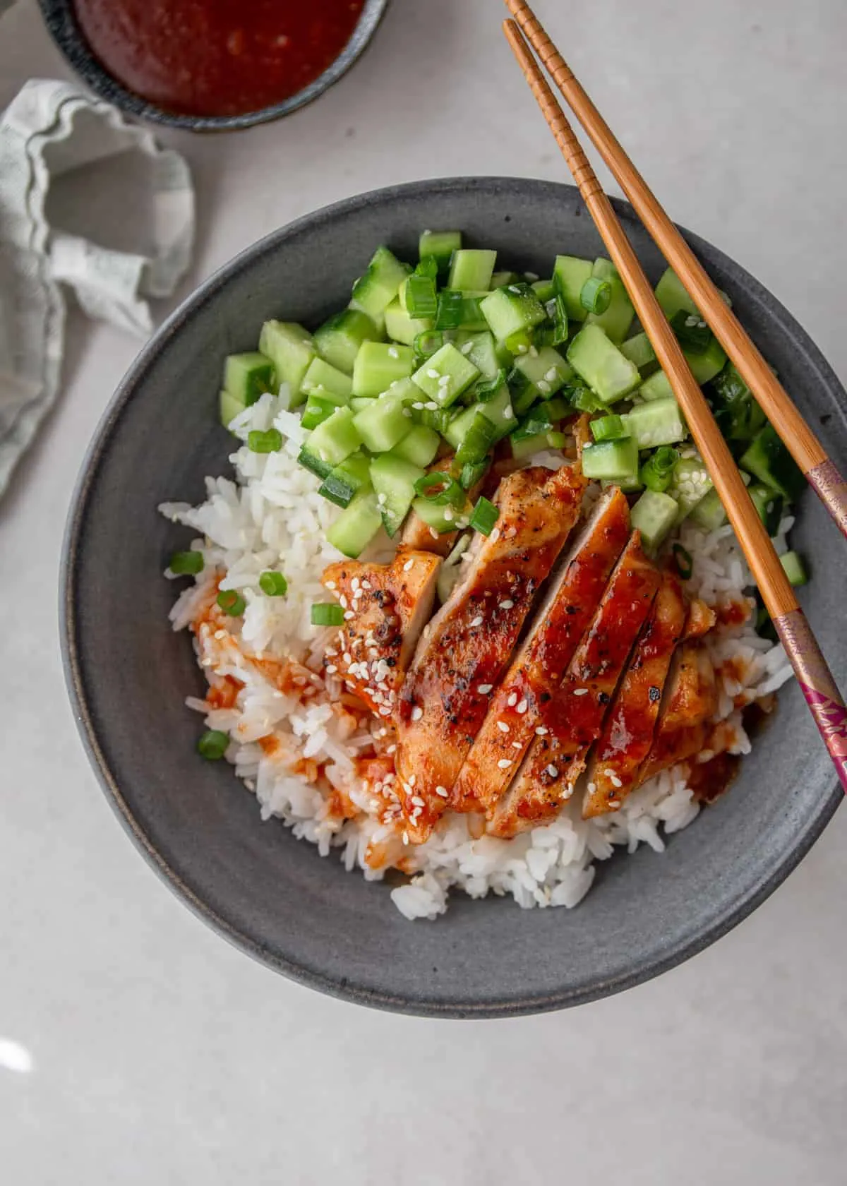 These chicken rice bowls feature tender chicken glazed in a sweet-and-spicy sauce and served over fluffy rice. They’re easy to adjust to your family’s taste and make a great option for busy weeknights or simple meal prep.