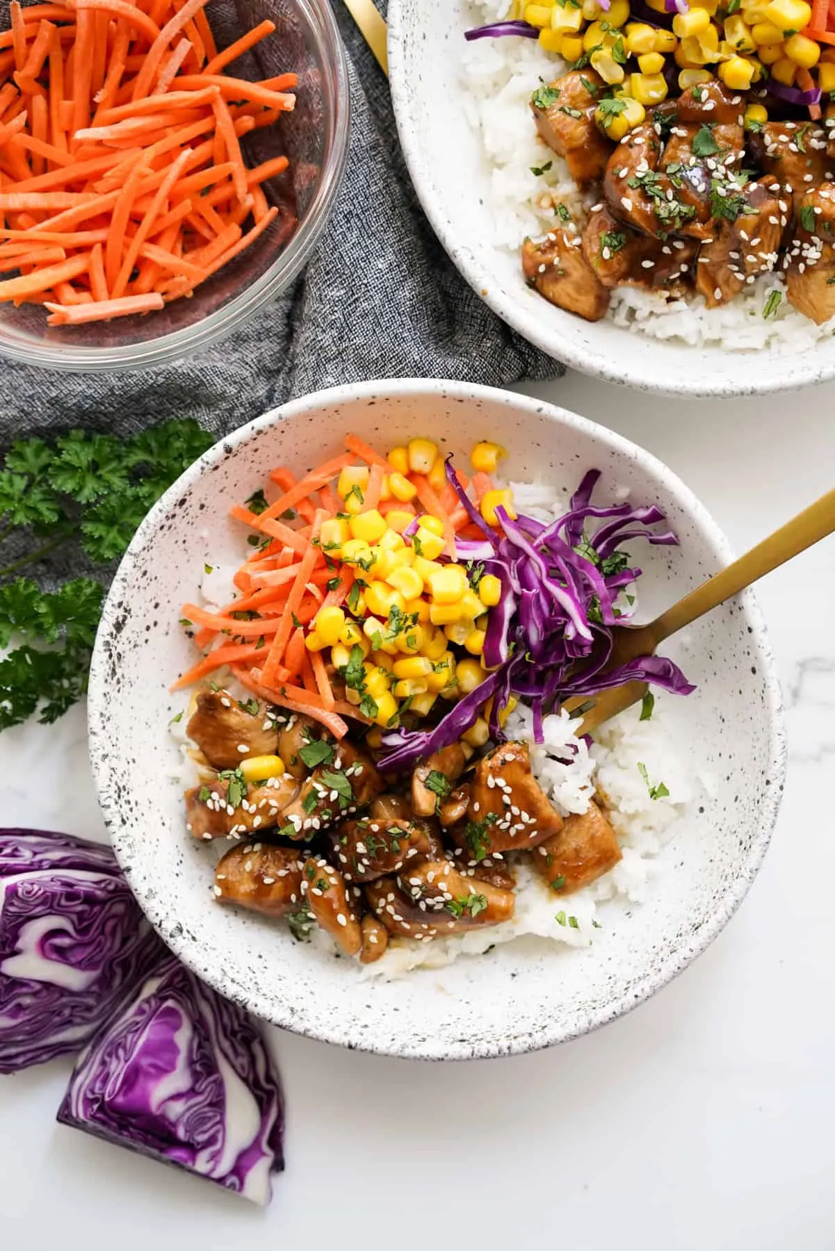 This soy glazed chicken rice bowl pairs tender, saucy chicken with fluffy rice, crisp carrots, cabbage, and sweet corn. Finished with fresh cilantro, it’s a quick, colorful meal that’s perfect for busy weeknights or simple meal prep.