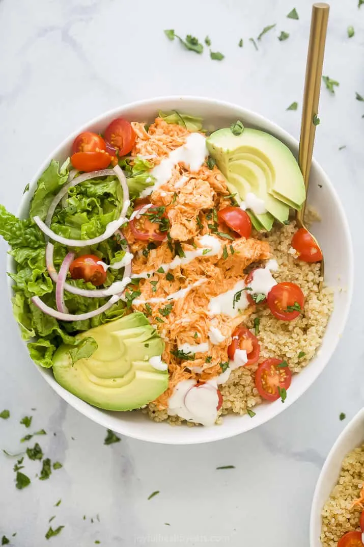 These Buffalo Chicken Quinoa Bowls are one of those meals that just works. You get spicy, saucy shredded buffalo chicken piled onto fluffy quinoa, then topped with creamy avocado, juicy tomatoes, crunchy lettuce, and a drizzle of cool ranch to bring it all together. It’s hearty without feeling heavy, full of texture, and perfect for when you want something that feels fresh but still totally satisfying. Whether you’re making it for dinner or packing it up for lunches, this bowl is always a win.