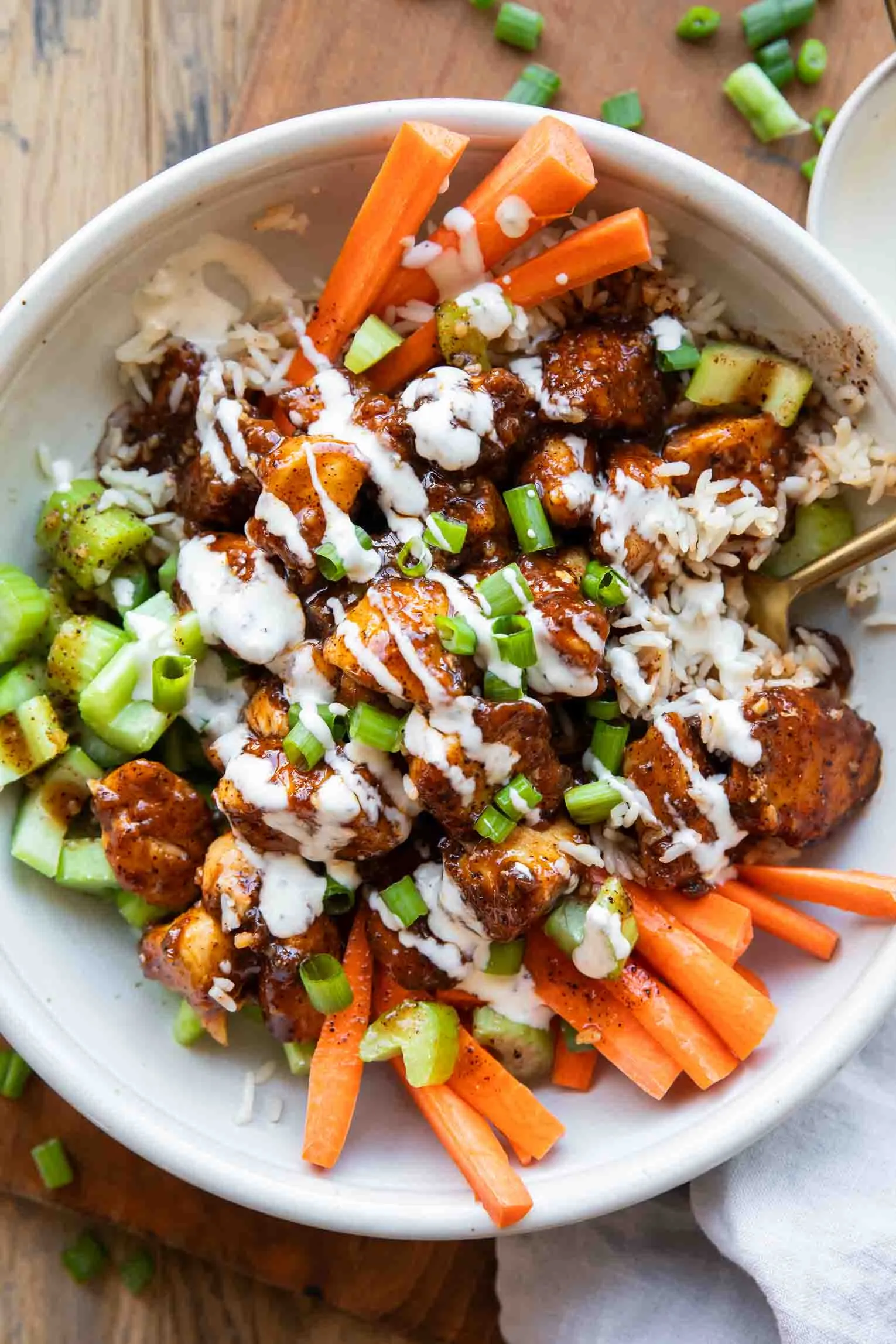 These Crispy Buffalo Chicken Bowls are packed with bold flavor and come together in under 40 minutes, making them perfect for busy weeknights. Juicy chicken gets coated in a sweet, savory, and lightly spicy buffalo sauce, then served over fluffy rice and fresh, crunchy veggies for a satisfying one-bowl meal. With plenty of protein and everything cooked in one pan, these bowls are an easy, fuss-free dinner that still feels exciting and filling.