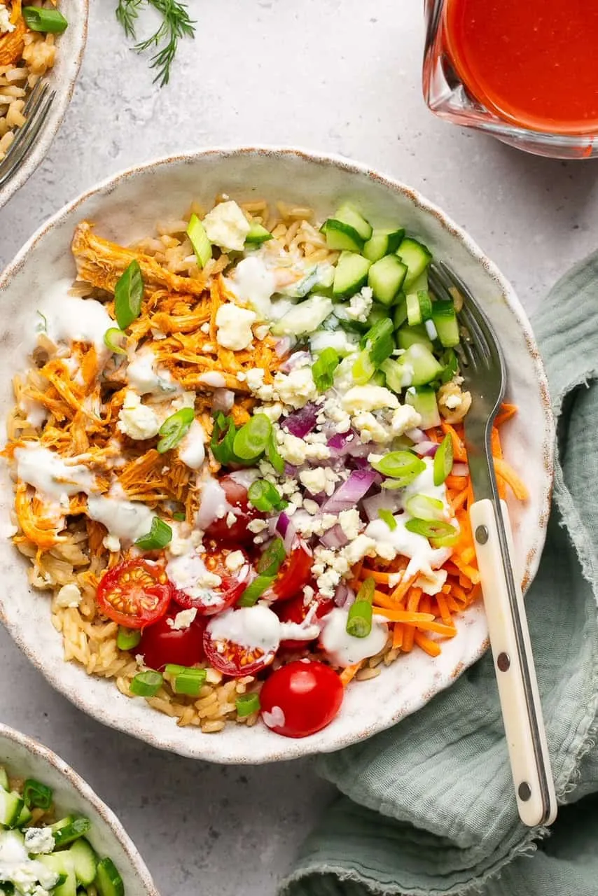These Easy Buffalo Chicken Rice Bowls are the kind of meal that checks every box — quick to make, totally customizable, and great for meal prep. Tender buffalo-style chicken is paired with hearty rice, fresh chopped veggies, and a creamy homemade ranch that pulls everything together. With a big boost of protein and tons of flavor, these bowls are just as good for weekday lunches as they are for family dinners.