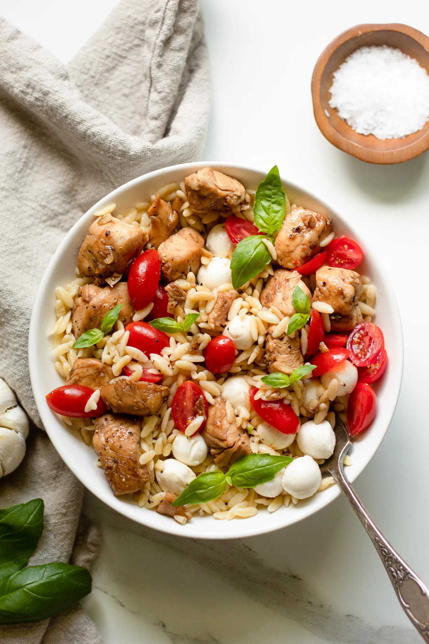 These Caprese chicken bowls are full of fresh, summery flavors with juicy cherry tomatoes, fragrant basil, melty mozzarella, and tender orzo. They come together easily, feel light but still satisfying, and work just as well for a quick dinner as they do for make-ahead lunches. A great chicken bowl option when you want something fresh and easy without turning on every burner in the kitchen.