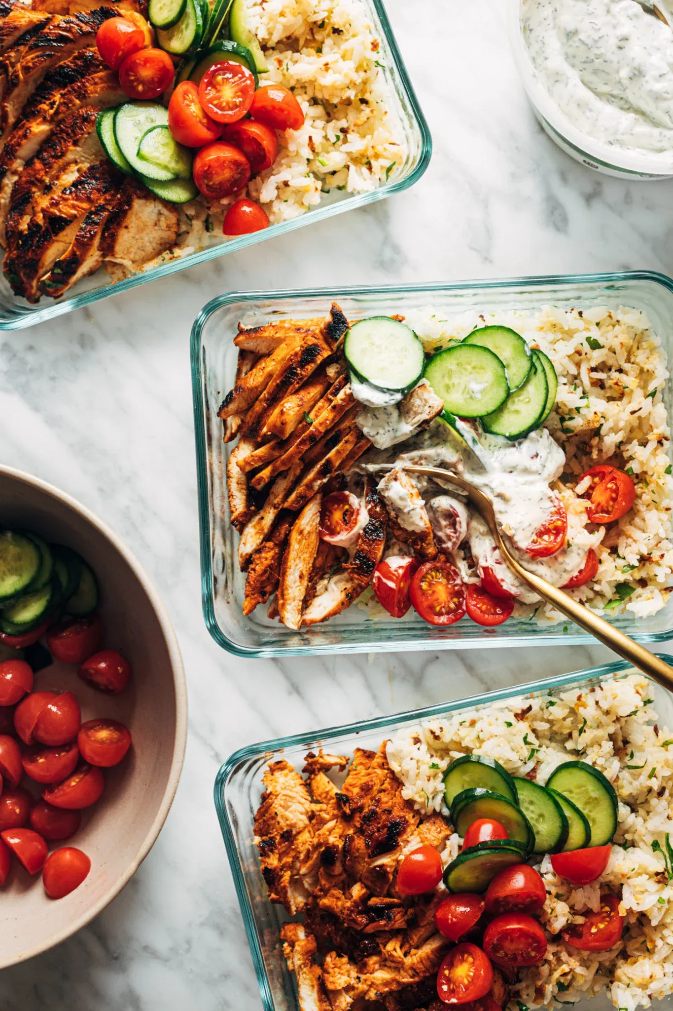 These buffalo chicken bowls are perfect for make-ahead lunches. Spicy chicken is served over a fluffy rice and cauliflower rice combo, then topped with juicy tomatoes, crunchy cucumbers, and a creamy dill dip that ties everything together.