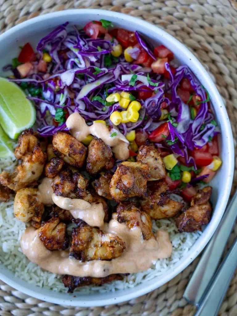 These peri peri chicken rice bowls feature crispy, golden chicken coated in a creamy peri peri-style sauce, served with fluffy rice and a crunchy cabbage salad. Ready in about 30 minutes, they’re a colorful, family-friendly option for easy weeknight dinners or simple meal prep.