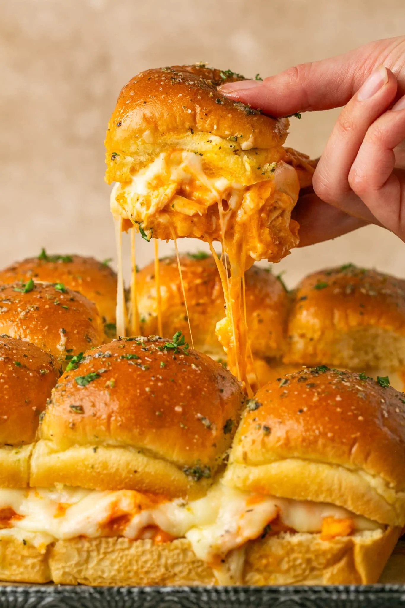 These Sheet Pan Buffalo Chicken Sliders are made with shredded chicken smothered in spicy buffalo sauce and a generous layer of gooey melted cheese all nestled between soft and buttery slider buns. It's an irresistible combination of cheesy goodness and zesty buffalo flavor. Perfect for your next game day party, outdoor BBQ, or for an easy appetizer or snack!