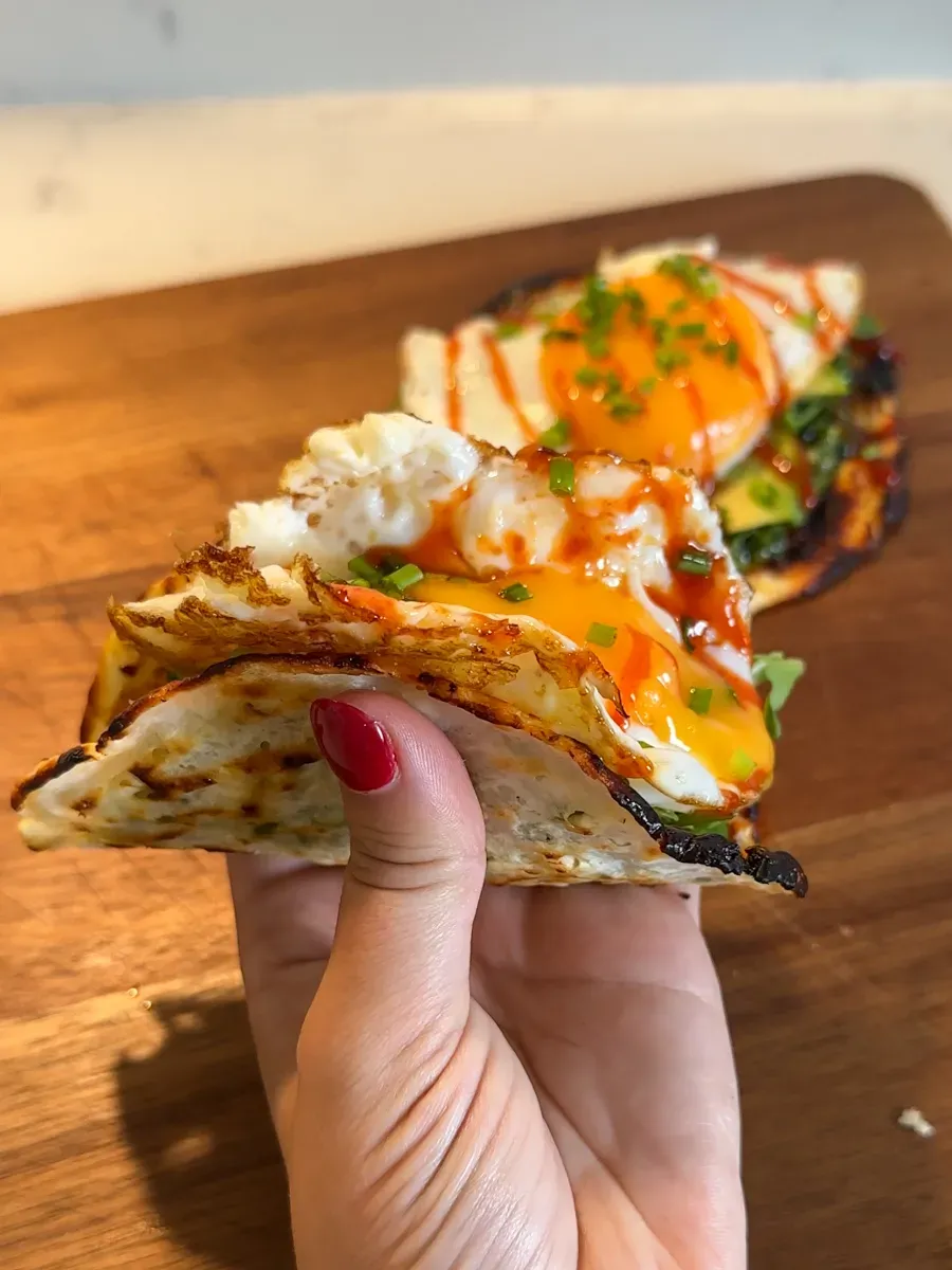 These high-protein cottage cheese breakfast tacos are a fun, savory way to start the day. With protein-packed cottage cheese and eggs forming a crispy base, they’re filling without being heavy. Finished with flavorful toppings like pesto, rocket, and a drizzle of sriracha, they’re perfect for post-workout fuel or a quick, satisfying breakfast that feels a little different from the usual.