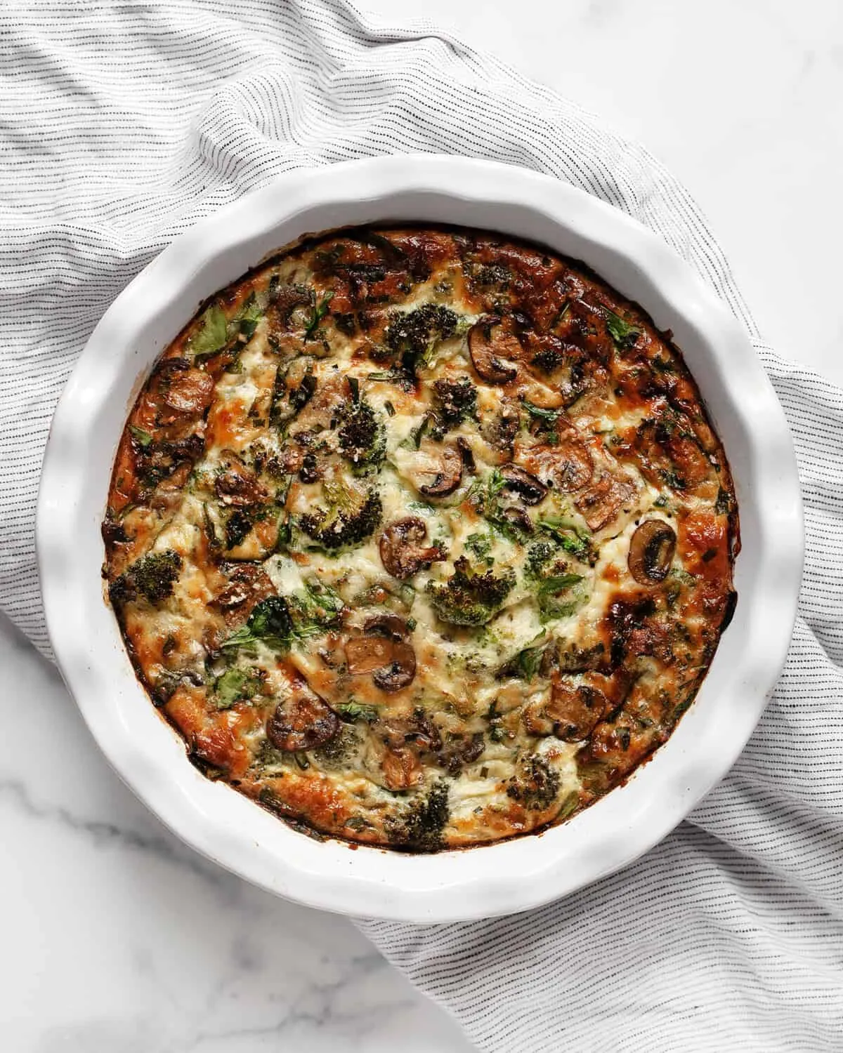 This cottage cheese egg bake is cozy, hearty, and packed with protein. Loaded with roasted broccoli, mushrooms, baby spinach, and a sprinkle of Parmesan, it bakes up creamy and satisfying in one simple dish. Perfect for breakfast, brunch, or even a light dinner, it’s a vegetarian meal that feels both nourishing and comforting.