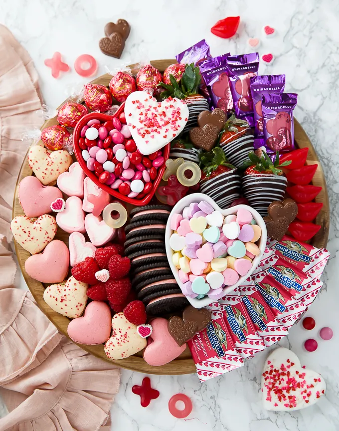 This pink food board is unapologetically fun and totally dessert-focused — perfect for Valentine’s parties, Galentine’s nights, or a kids’ Valentine celebration where sugar is very much the point. The vibe is playful, colorful, and a little extra, making it ideal for sharing, snapping photos, and letting everyone pick their favorites. It’s also a great fit for a family movie night or any pink-themed celebration where you want the table to feel cheerful and indulgent rather than formal.