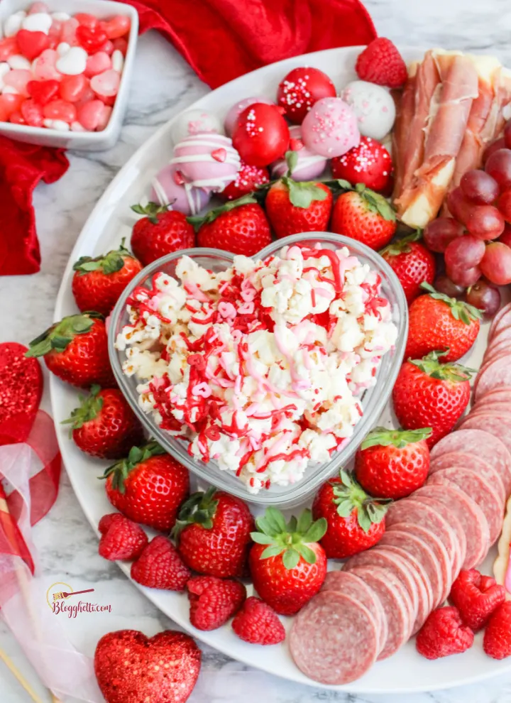 This pink food board strikes a really nice balance between playful and polished, making it perfect for Valentine’s parties, family movie night, or a mixed-age gathering where you want a little bit of everything. With both sweet treats and savory bites, it feels festive without leaning too far in one direction. It’s especially great for sharing — the kind of board people can graze from while chatting, watching a movie, or celebrating together without it feeling too formal.