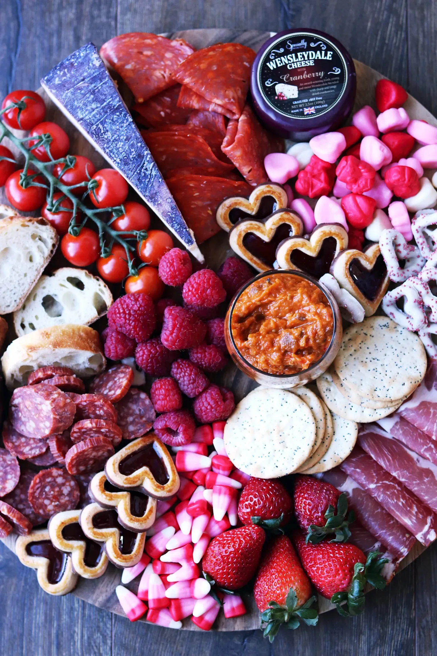 This pink food board is ideal for a Valentine’s gathering where the goal is grazing, chatting, and lingering rather than piling up sweets. It leans confidently savory with just a few playful pink touches mixed in, giving it a bold, slightly indulgent feel that works beautifully for an adults-only evening or a wine-and-cheese night. It’s the kind of board that feels generous and unfussy — perfect when you want something that looks impressive but still feels relaxed and social.