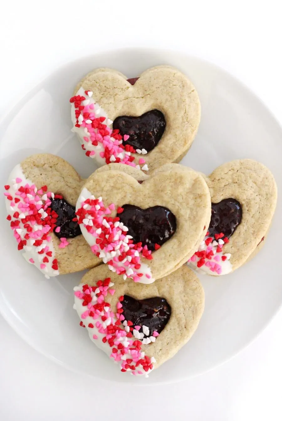 These gluten-free heart-shaped cookies are made for Valentine’s Day and fun to decorate. Filled with raspberry jam and topped with dairy-free white chocolate and sprinkles, they’re a sweet Linzer-style treat that everyone can enjoy. Being vegan and allergy-friendly means they’re perfect for sharing without worry.
