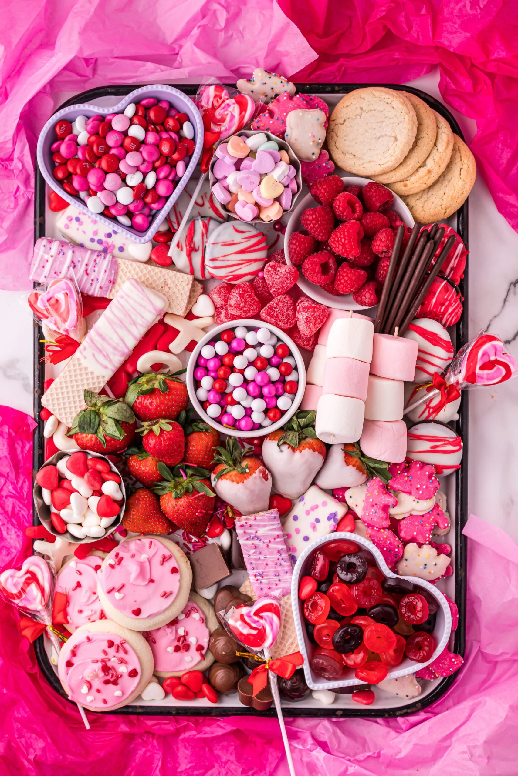 This cute pink food board is bright, playful, and overflowing with Valentine’s charm, making it perfect for a kids’ party or a fun family celebration. The overall vibe is cheerful and whimsical, with lots of small, colorful treats that feel exciting and easy to grab. It’s the kind of board that instantly feels special and festive — ideal when you want something that looks adorable on the table and gets everyone smiling before they even start snacking.