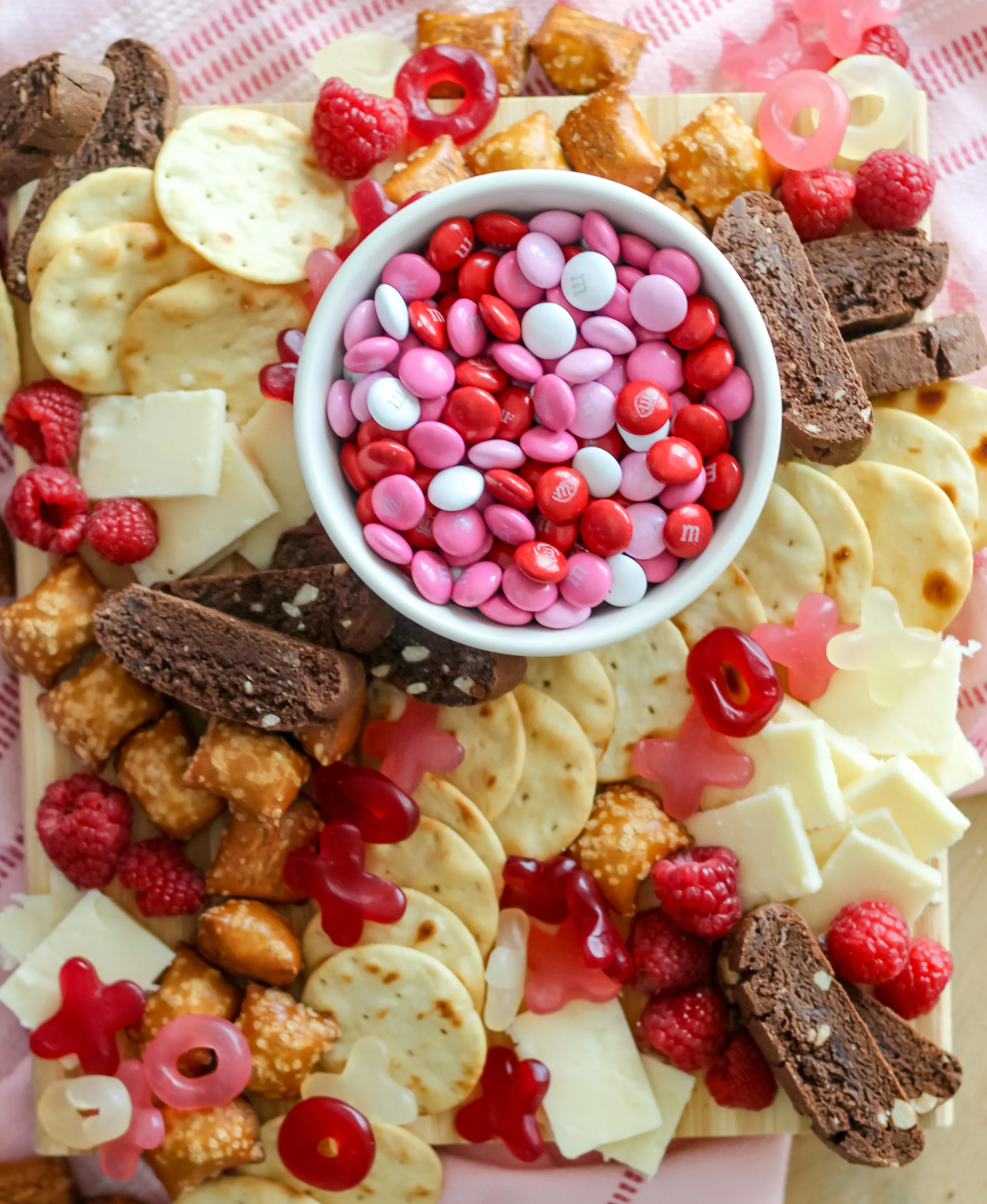 This pink food board feels cozy and low-key, making it a great pick for a Valentine’s family movie night or a relaxed evening in. It leans more snacky than fancy, with a mix of sweet treats and easy nibbles that feel familiar and comforting. The overall vibe is casual and inviting — the kind of board you set out on the coffee table and graze from while the movie plays and everyone steals a little extra chocolate.