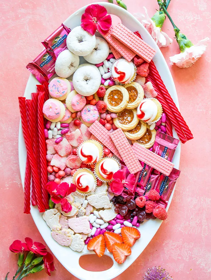 This pink snacks for party board feels bright, cheerful, and made for celebrating, making it a great fit for a Valentine’s party or Galentine’s get-together. The overall vibe is playful and polished at the same time, with everything styled to look inviting and fun without feeling chaotic. It’s perfect when you want a dessert spread that doubles as table décor and encourages guests to snack, mingle, and keep coming back for “just one more.”