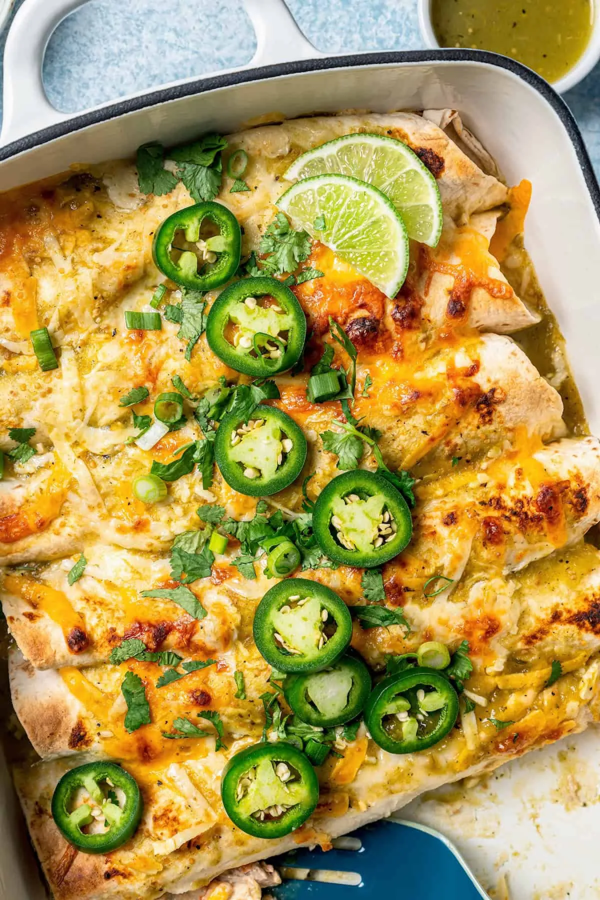 These chicken enchiladas are filled with a creamy chicken mixture made with tomatoes and green chilies, then smothered in green enchilada sauce and plenty of cheese. Baked until hot and bubbly, they’re an easy, comforting dinner that’s perfect for busy nights when you want something hearty and satisfying without extra effort.