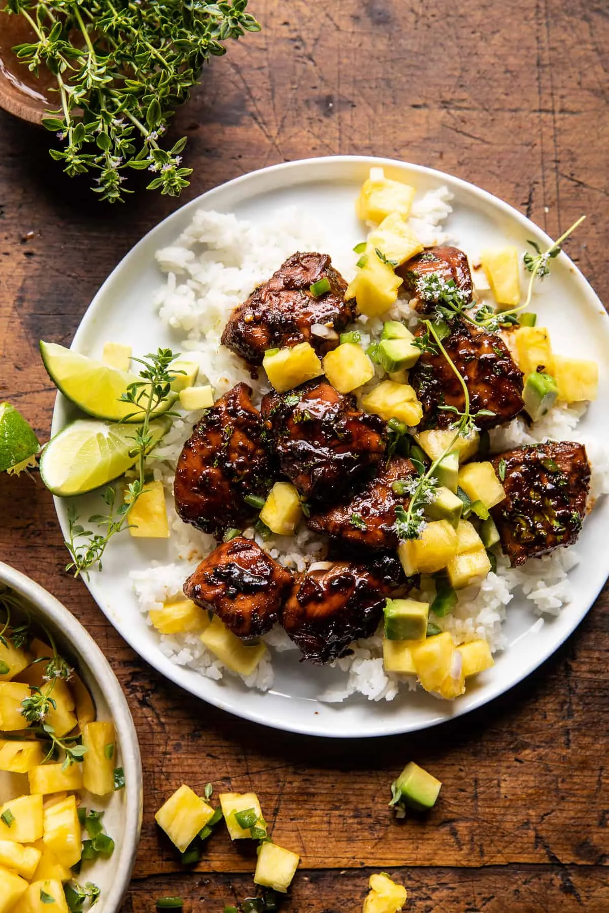 This 30-minute pineapple chicken is a perfect balance of sweet, salty, and just a little spicy. Quick-cooking chicken is coated in a pineapple soy marinade, then served over creamy coconut rice and topped with fresh pineapple salsa and avocado. It’s an easy, summery dinner that feels special but still works beautifully for busy weeknights.