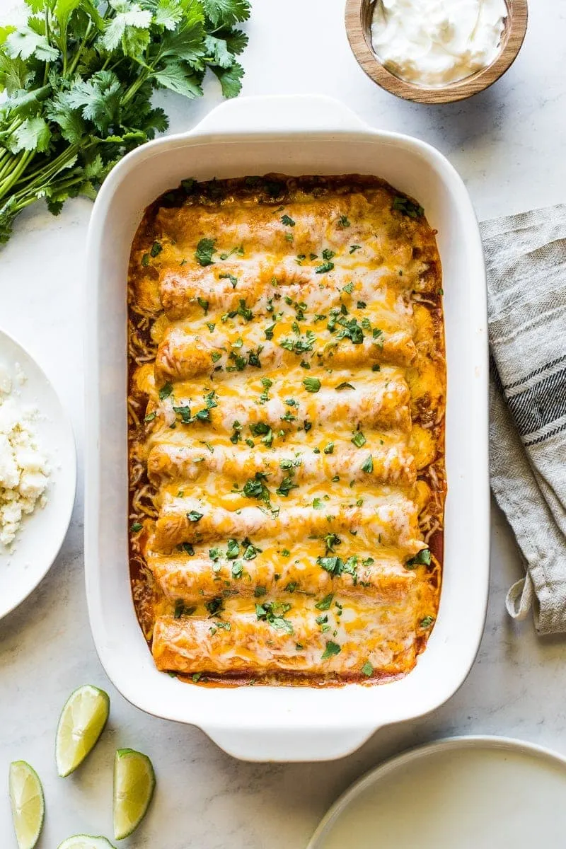 These classic chicken enchiladas are simple, comforting, and always a hit. Corn tortillas are filled with shredded chicken and cheese, then topped with a rich enchilada sauce and baked until bubbly and golden. Easy enough for regular weeknight dinners but special enough for celebrations, they’re the kind of enchilada recipe you’ll come back to again and again.