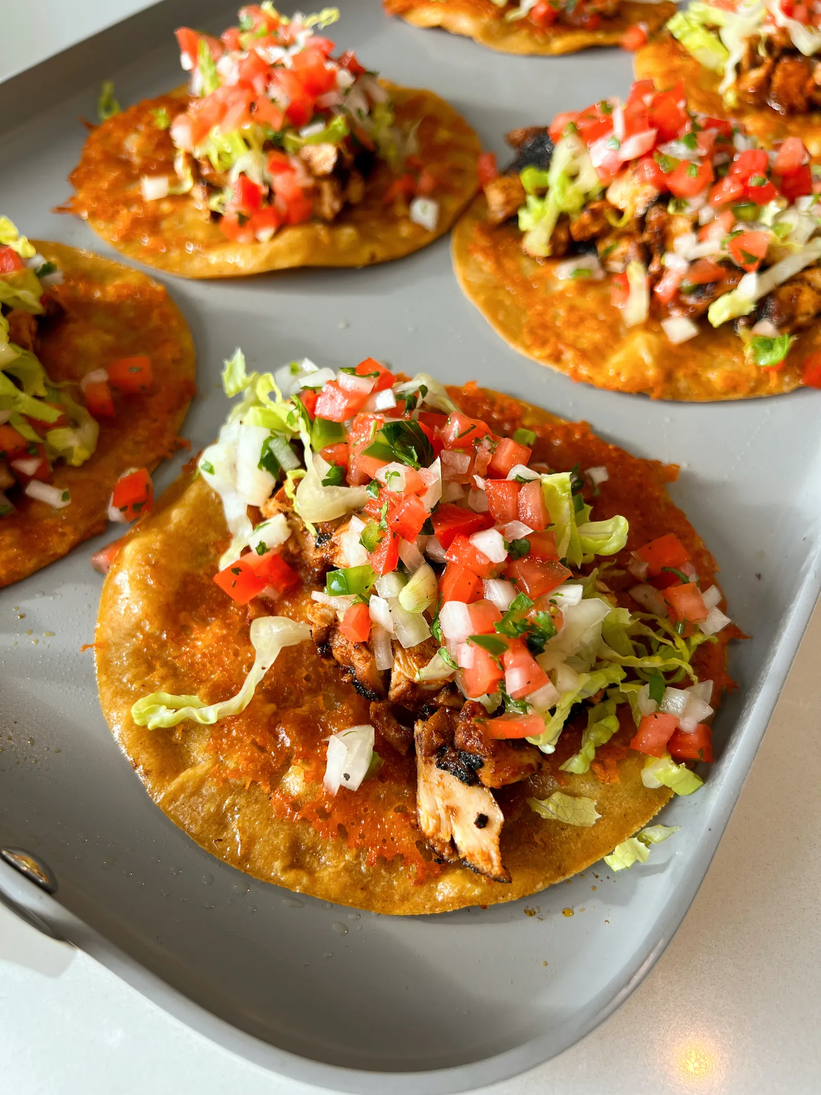 These crispy cheesy chipotle chicken tacos are the kind of tacos that make everyone hover around the pan waiting for the next one to come out. Each soft flour tortilla gets a layer of melted, golden cheese, then it’s filled with juicy chipotle-spiced chicken thighs and topped with fresh homemade pico de gallo. They’re bold, messy in the best way, and surprisingly easy to pull together at home. Perfect for taco night when you want something that feels a little extra without turning dinner into a whole production. 
