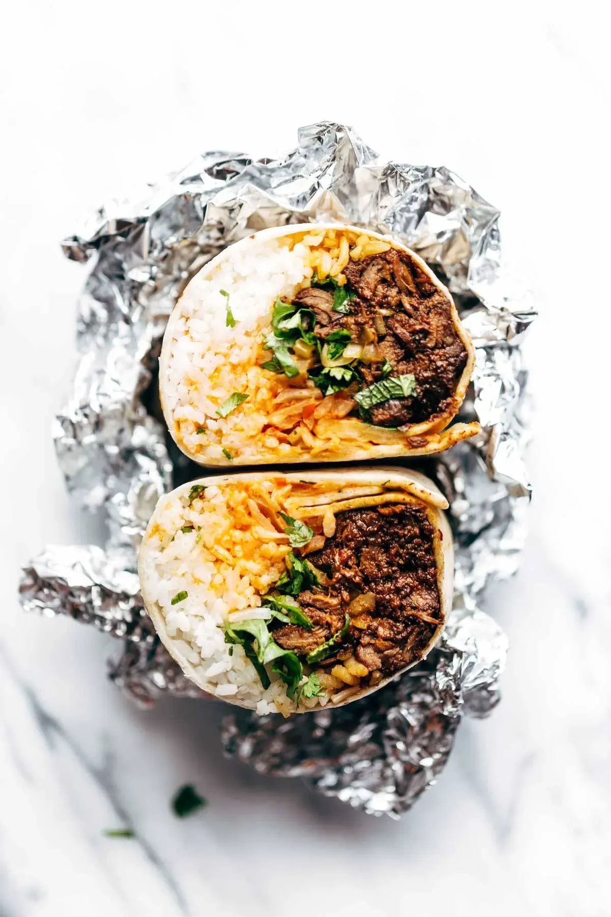These Korean BBQ burritos are a bold, fusion-style mashup that packs serious flavor into a soft flour tortilla. Garlicky, ginger-forward beef is layered with spicy kimchi, fluffy rice, fresh herbs, and a generous drizzle of creamy yum yum sauce. The result is a crave-worthy burrito that feels a little different from the usual lineup but still delivers that satisfying, handheld comfort burritos are known for.