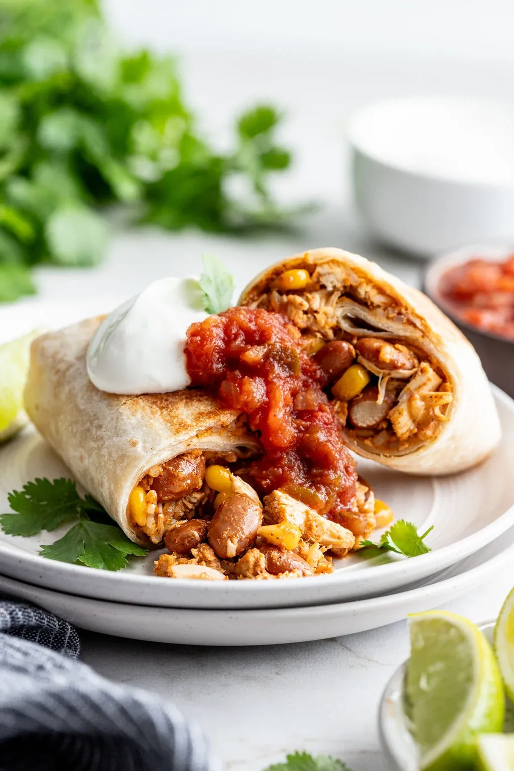 These slow cooker chicken burritos are an easy, hands-off way to make a hearty burrito filling with minimal effort. Chicken cooks alongside beans, corn, rice, enchilada sauce, and cheese, then gets rolled into warm flour tortillas for a filling, comforting meal. They’re great for busy weeknights, packing up for lunches, or freezing for later when you want dinner ready to go.