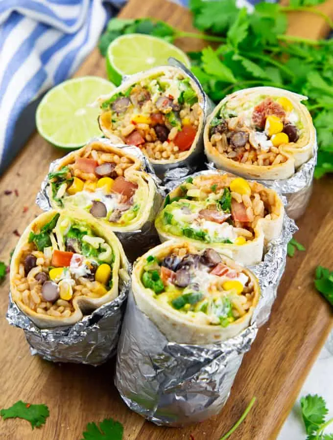 These vegan burritos are filled with brown rice, black beans, sweet corn, creamy vegan sour cream, and guacamole for an easy, comforting dinner. Wrapped in soft flour tortillas, they come together quickly and are perfect for simple weeknight meals when you want something filling without a lot of effort.