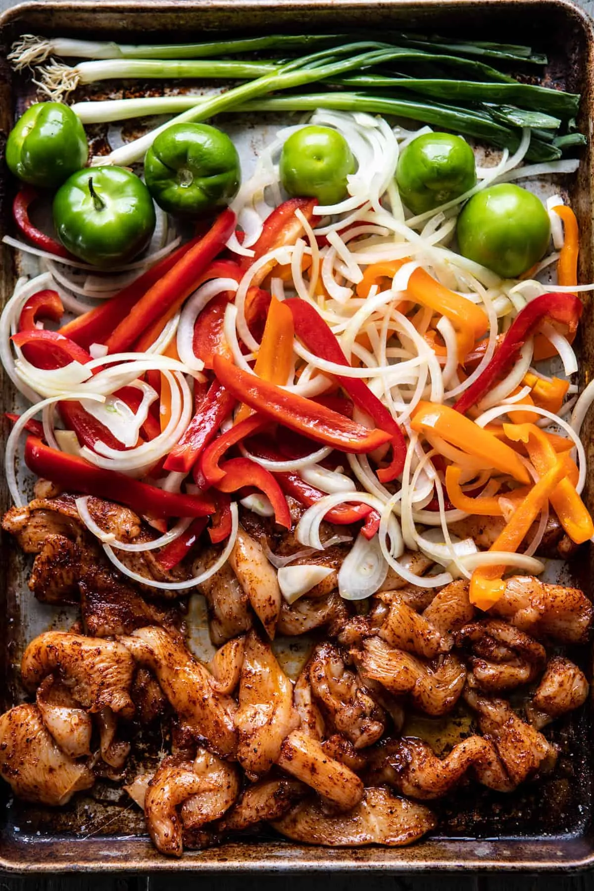 These 30-minute chicken fajitas with roasted pineapple salsa verde are colorful, fresh, and full of smoky flavor. The seasoned chicken, peppers, and onions roast together on one sheet pan, then get topped with a tangy tomatillo-pineapple salsa that really makes the dish pop. It’s a healthy, weeknight-friendly dinner that also works great for meal prep and easy lunches.