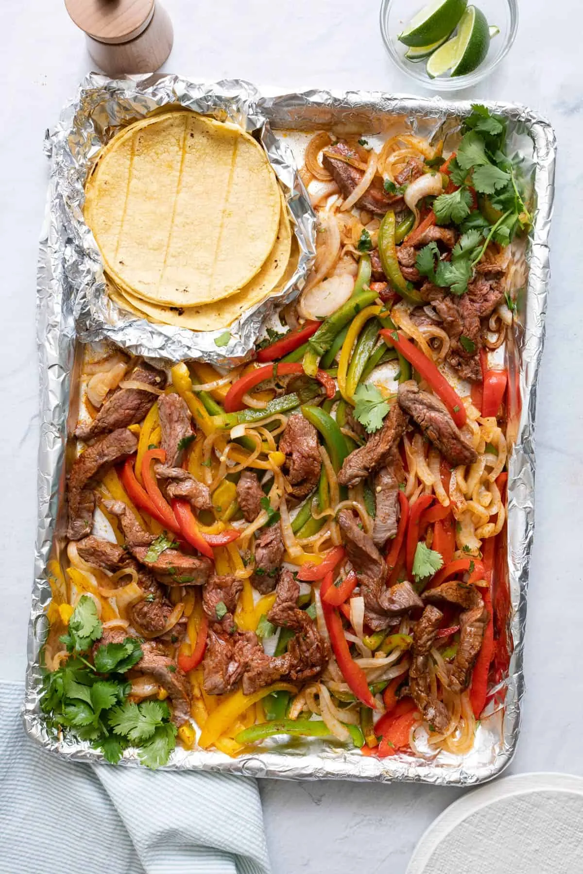 These sheet pan steak fajitas are an easy win for busy weeknights. With just six simple ingredients, everything roasts together until the beef is tender and the peppers and onions are perfectly caramelized. They’re ready in about 30 minutes and only require one pan, which makes both dinner and cleanup refreshingly simple.
