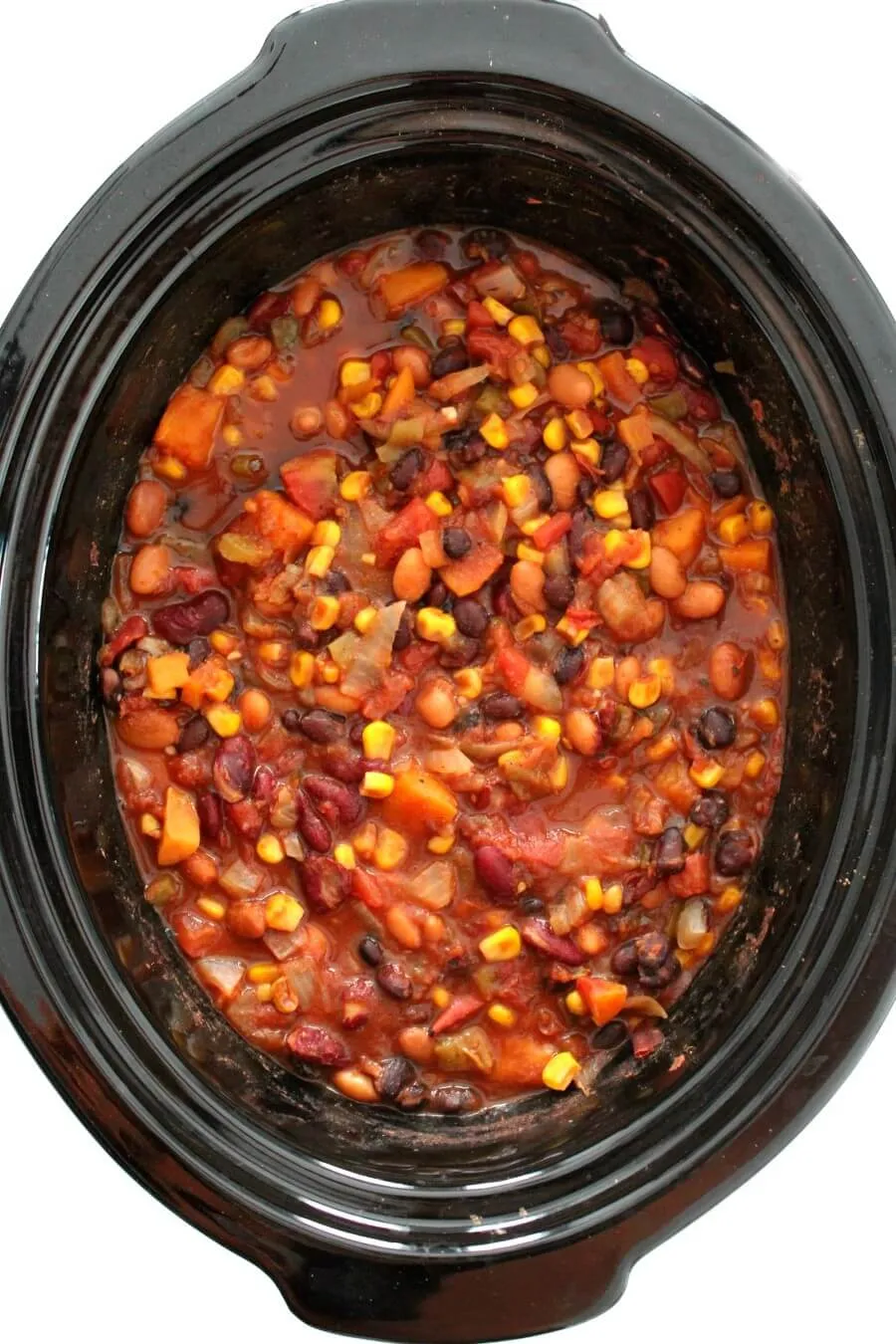 This slow cooker vegetarian chili is a true dump-and-go meal you can set and forget. Made with three kinds of beans, plenty of veggies, and bold Southwest flavor, it’s hearty, comforting, and packed with plant-based protein. Vegan, gluten-free, and freezer-friendly, it’s perfect for feeding a crowd or stocking your freezer with easy, meatless meals.